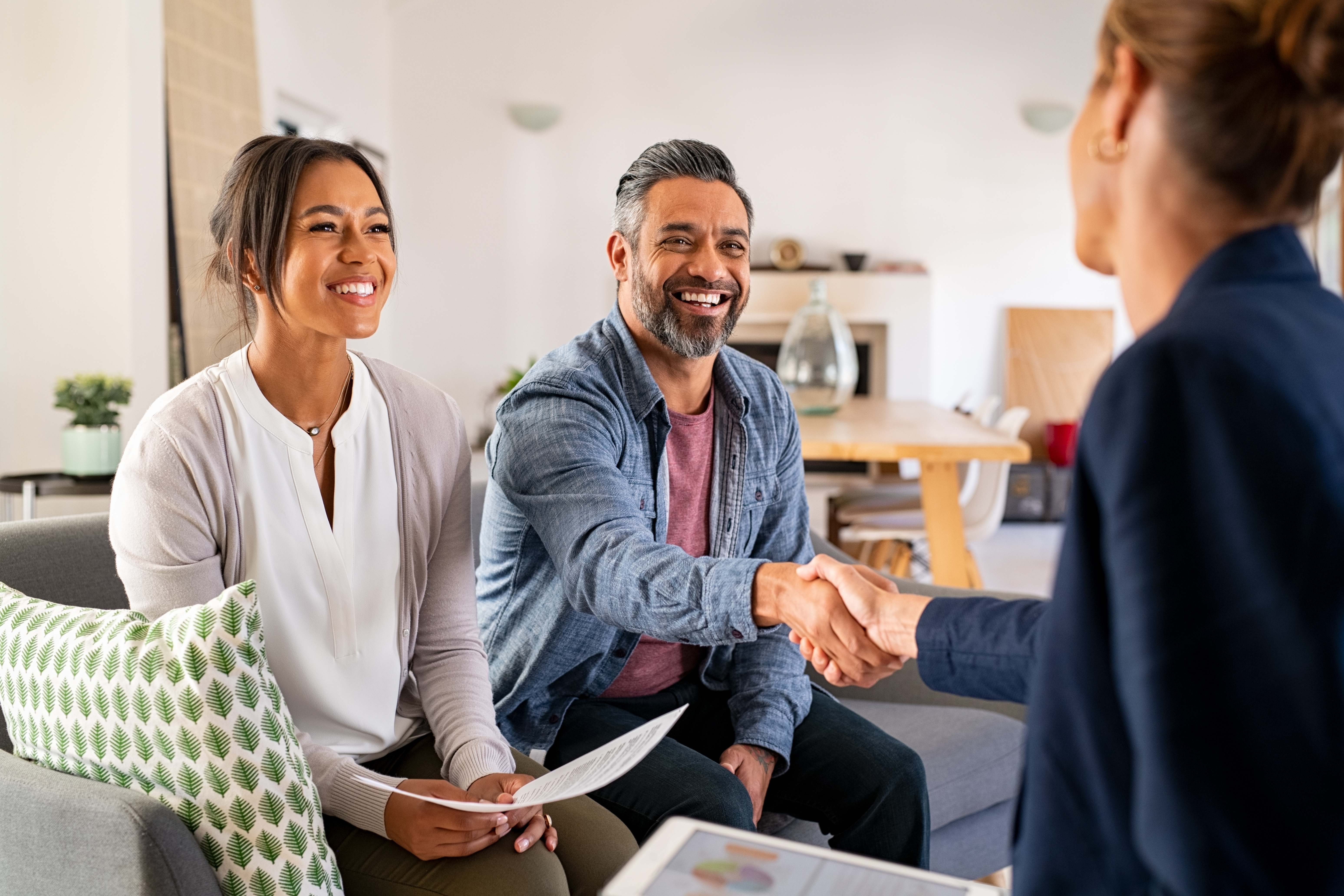 Happy couple meeting with real estate agent